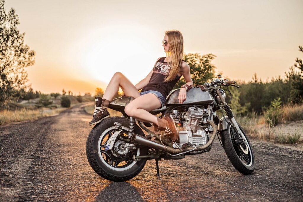 Байкерша на мотоцикле на закате